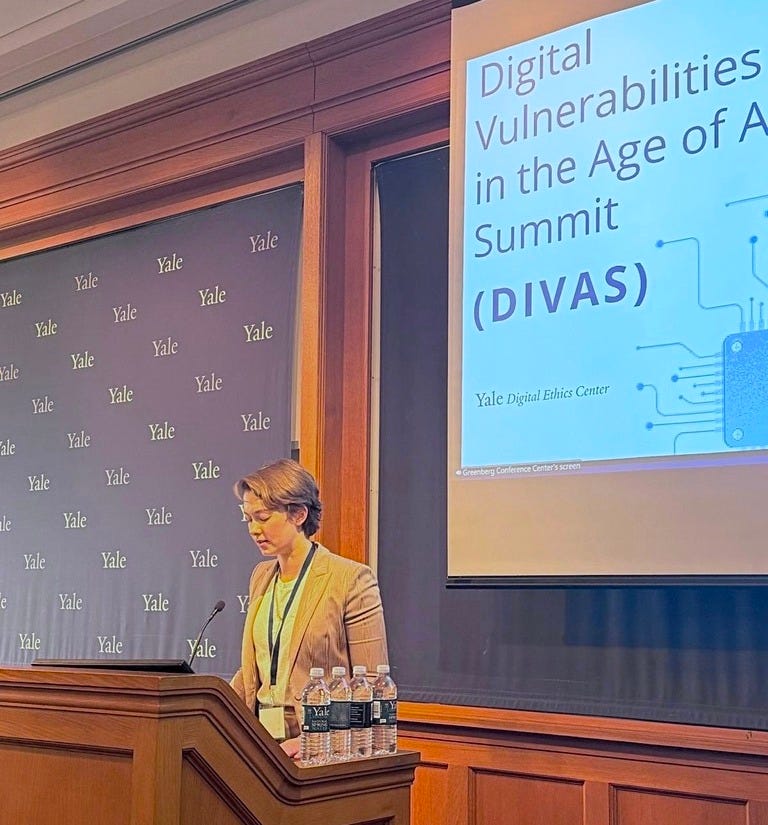 The author standing at a lectern in front of a Yale backdrop.