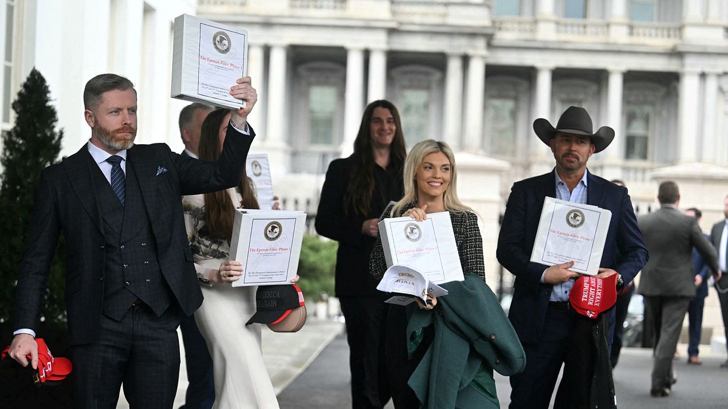 Political commentator Rogan O'Handley, aka DC Draino, TikToker Chaya Raichik, US conservative activist Scott Presler, commentator Liz Wheeler and US conservative political commentator Chad Prather carry binders bearing the seal of the US Justice Department reading "The Epstein Files: Phase 1." Political commentator Rogan O'Handley, aka DC Draino, TikToker Chaya Raichik, US conservative activist Scott Presler, commentator Liz Wheeler and US conservative political commentator Chad Prather carry binders bearing the seal of the US Justice Department reading "The Epstein Files: Phase 1."