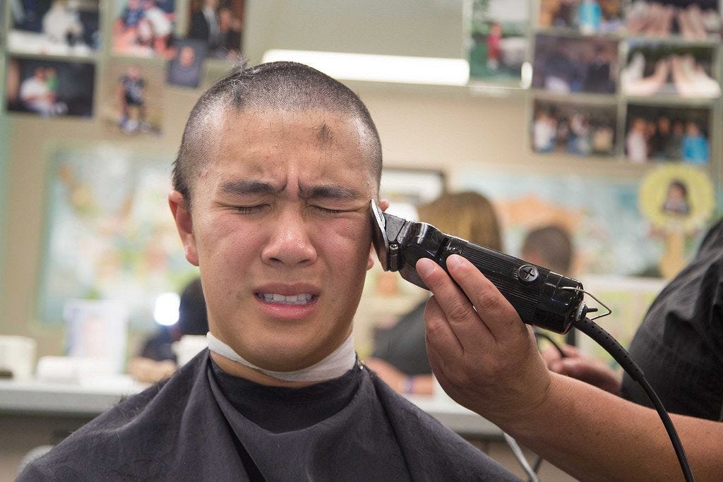 A person getting his hair cut

Description automatically generated