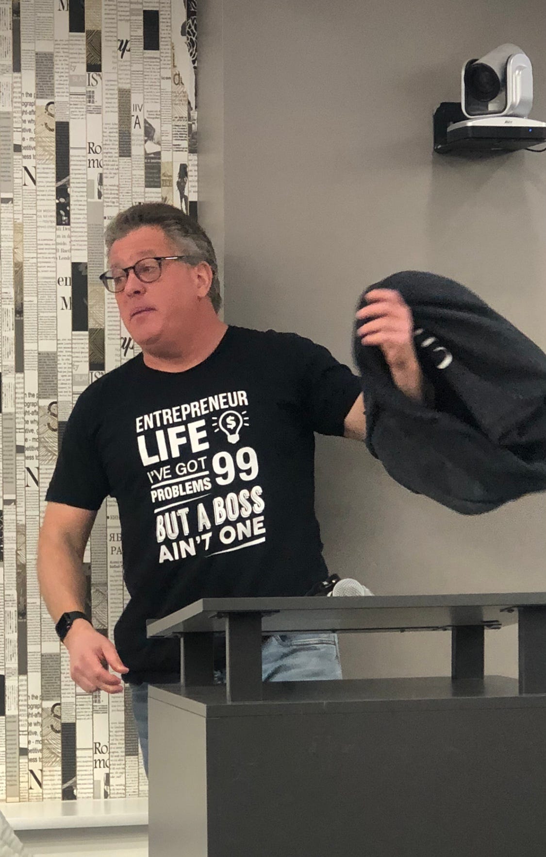 Peter Shankman speaking at the 2026 Small Giants NYC Conference, wearing a shirt with text about entrepreneurial life.