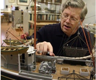 A person working on a model ship
Description automatically generated A person working on a model ship
Description automatically generated