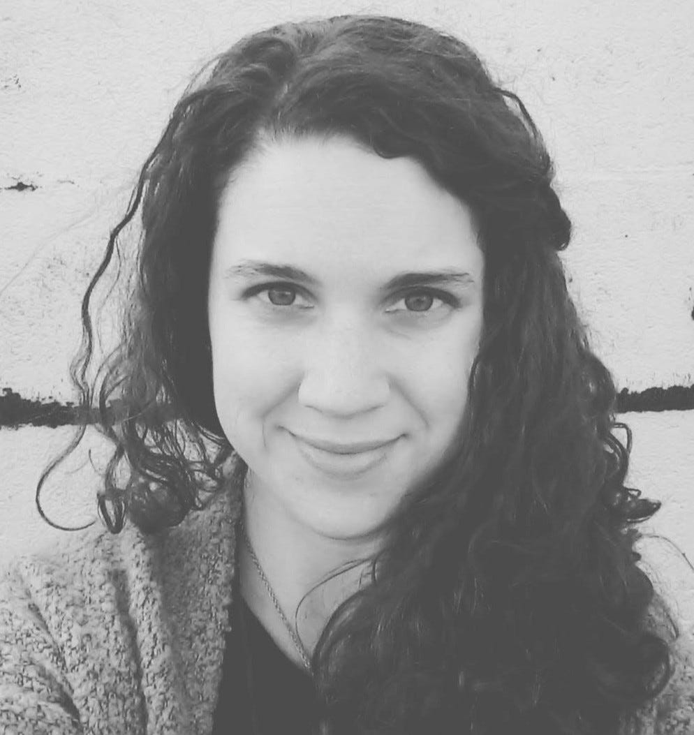 A black and white picture of SE Reid standing beside a wall A black and white picture of SE Reid standing beside a wall