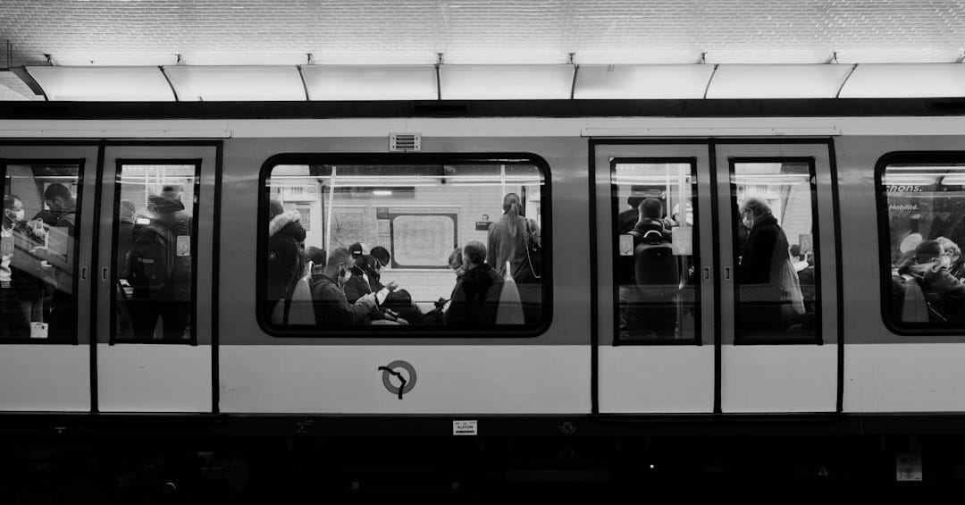 a black and white photo of people on a train