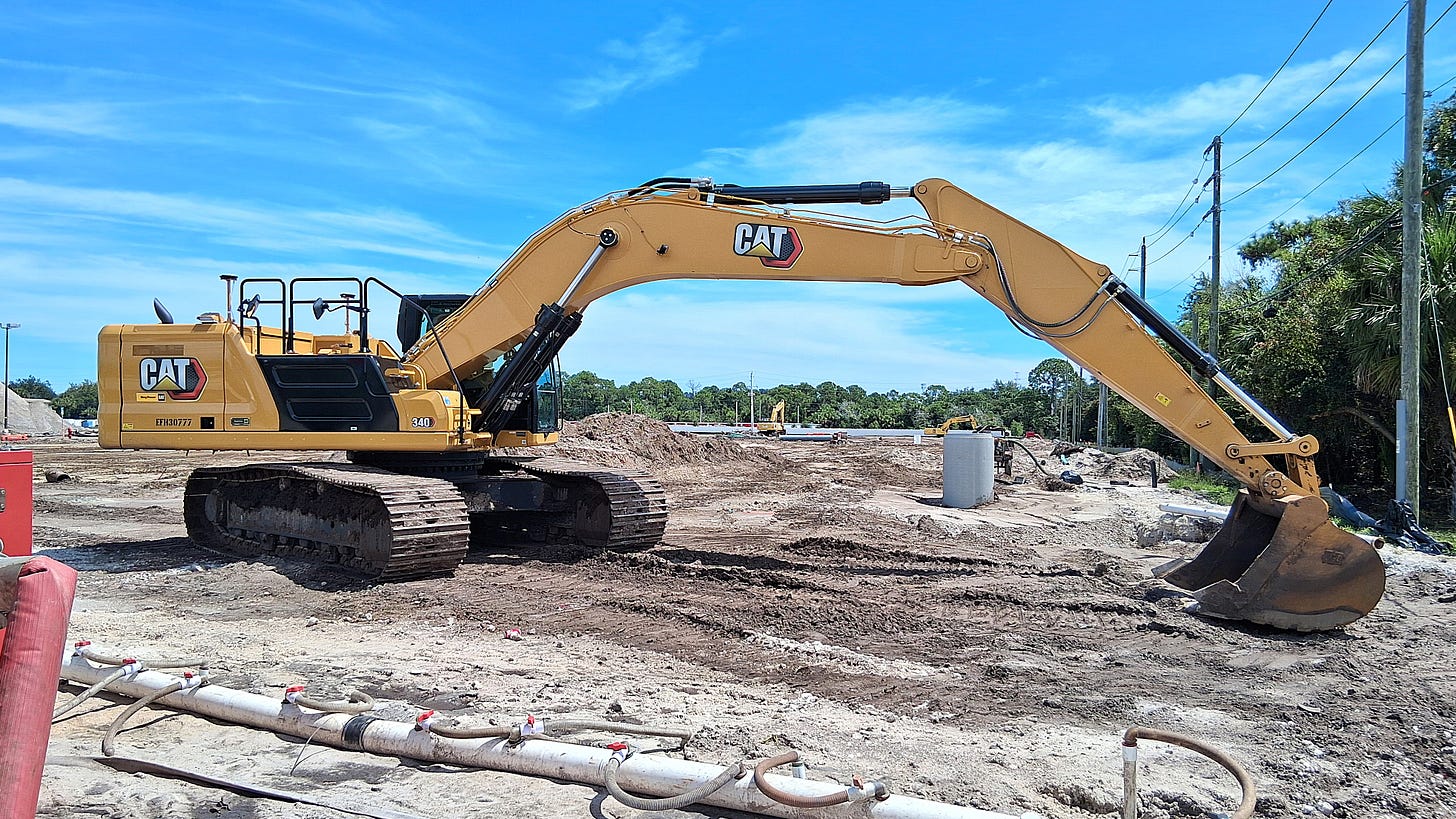 A CAT excavator rests after clearing away the old Publix grocery store plaza. Palm Bay Road and Babcock Street, Palm Bay, Florida, 2026. A CAT excavator rests after clearing away the old Publix grocery store plaza. Palm Bay Road and Babcock Street, Palm Bay, Florida, 2026.