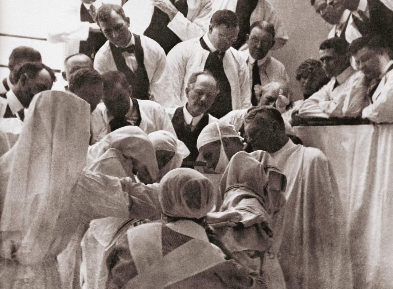 Charles Mayo, of the Mayo Clinic, demonstrating a surgical procedure in 1913.