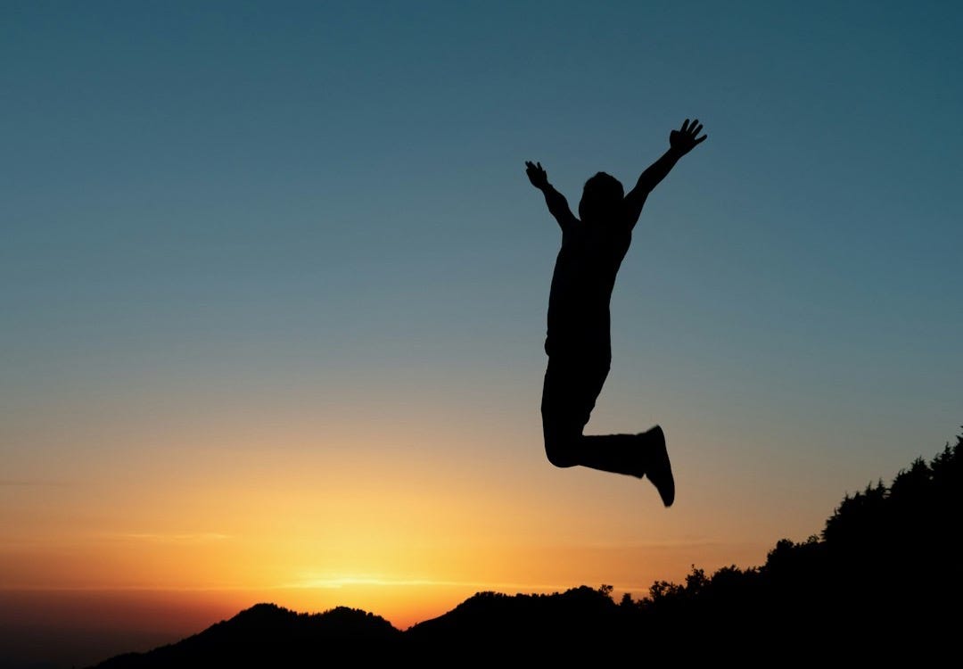 silhouette of jumping man during sunset silhouette of jumping man during sunset
