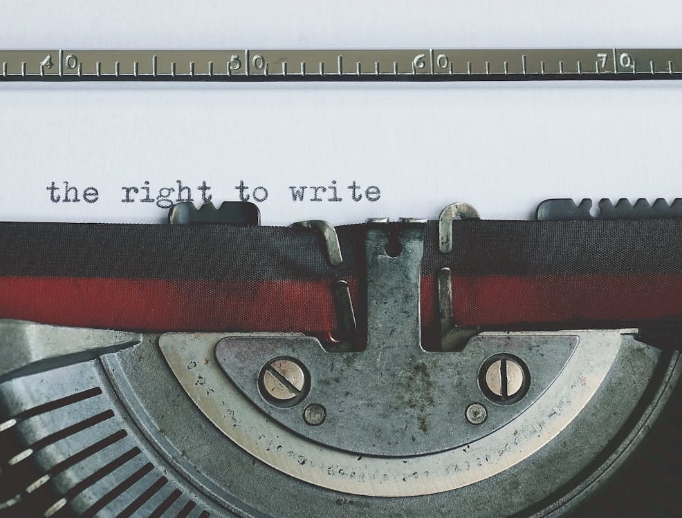 Free Close-up of a vintage typewriter with 'the right to write' typed on paper. Stock Photo Free Close-up of a vintage typewriter with 'the right to write' typed on paper. Stock Photo