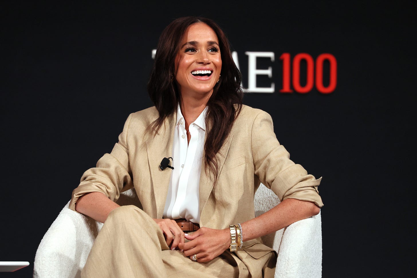 Meghan Markle wearing tan suit on stage at TIME100 Summit