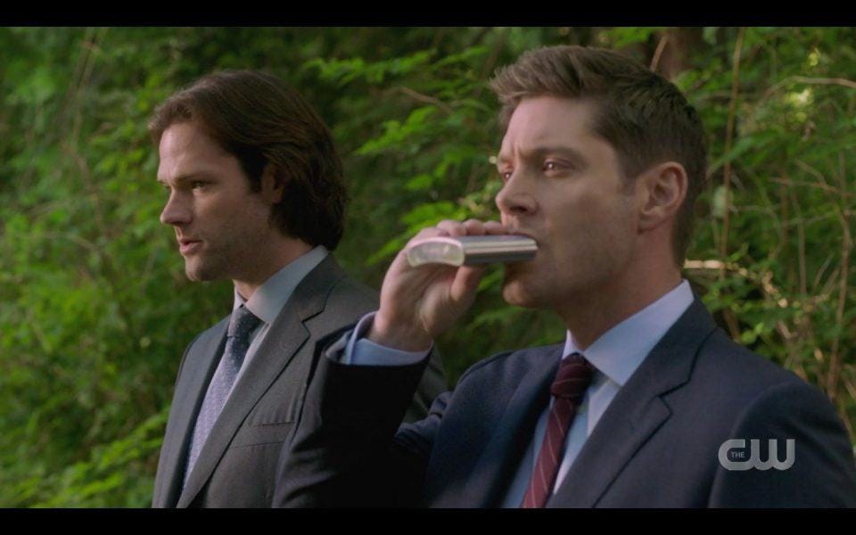 Dean Winchester taking drink from flask in front of Sam SPN 1504 Dean Winchester taking drink from flask in front of Sam SPN 1504