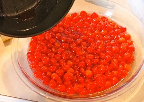 Pouring cherry mixture into glass pie pan
