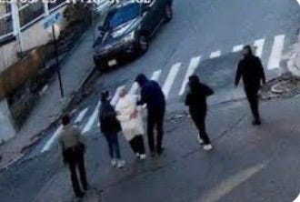 A group of people standing on a street

AI-generated content may be incorrect.