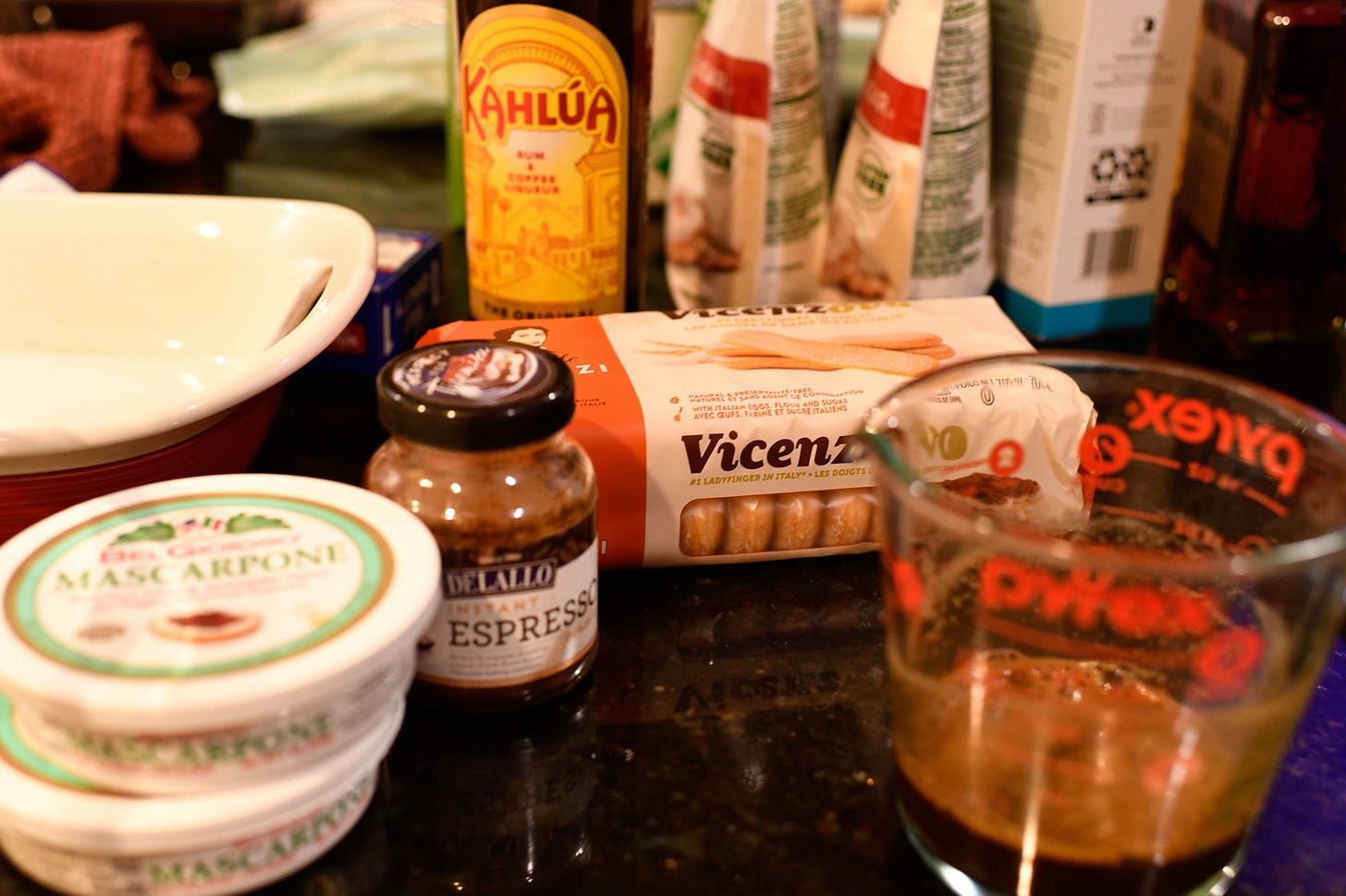 an array of ingredients for making tiramisu on a kitchen counter
