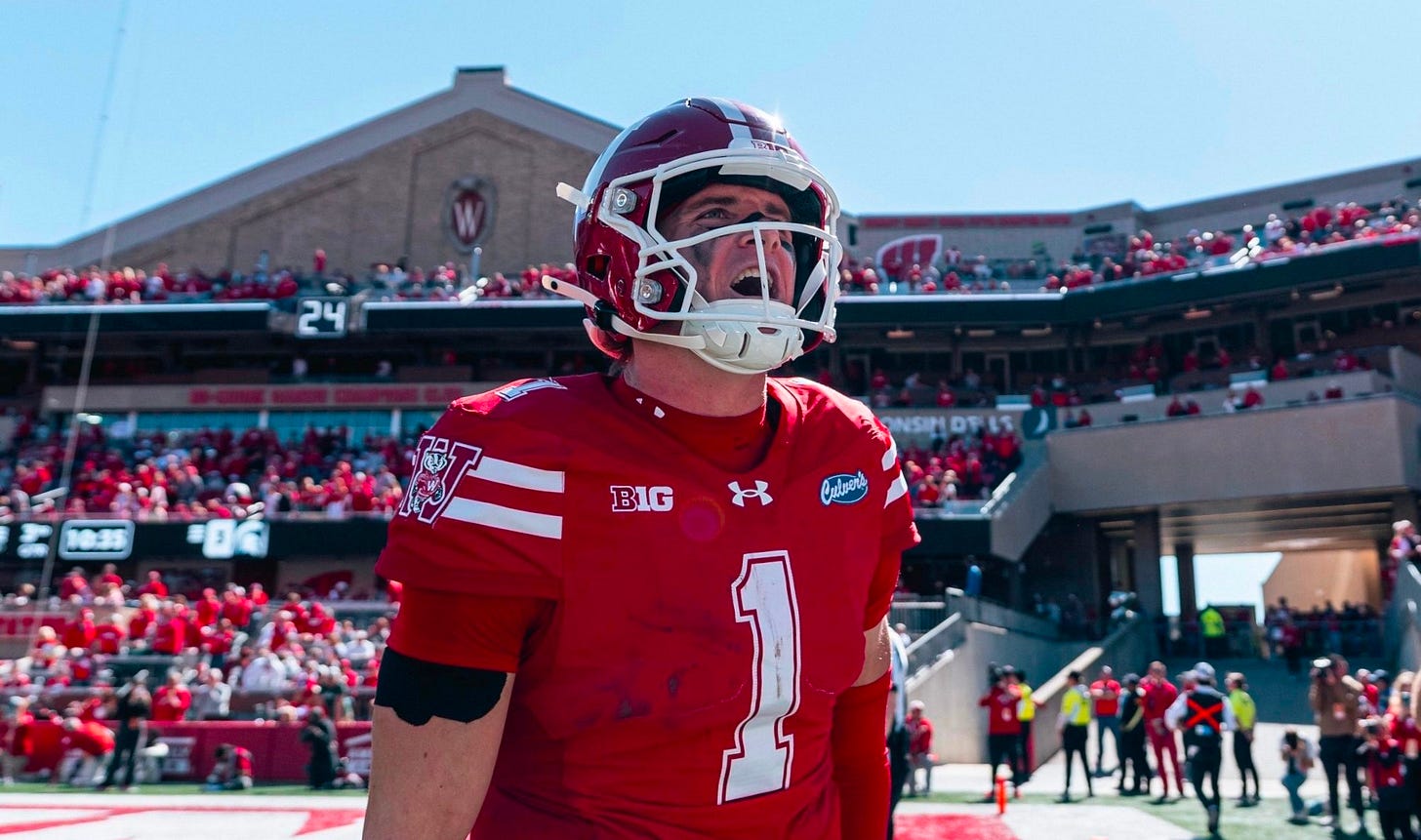 Wisconsin Badgers quarterback Colton Joseph walks off the field after scoring a rushing touchdown.