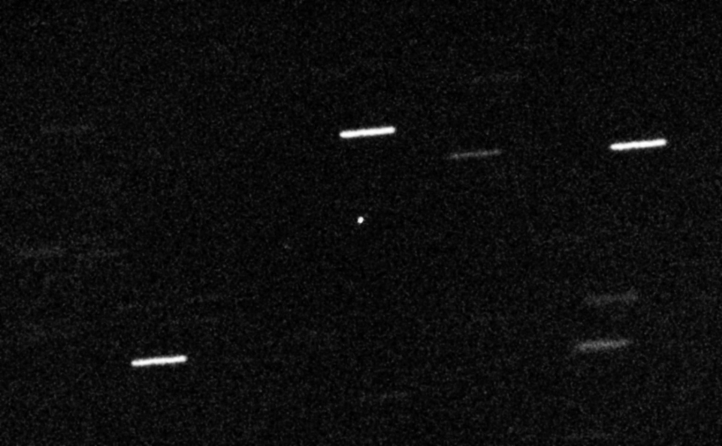 A photo of space showing some white streaks here and there as well as a bright white dot.