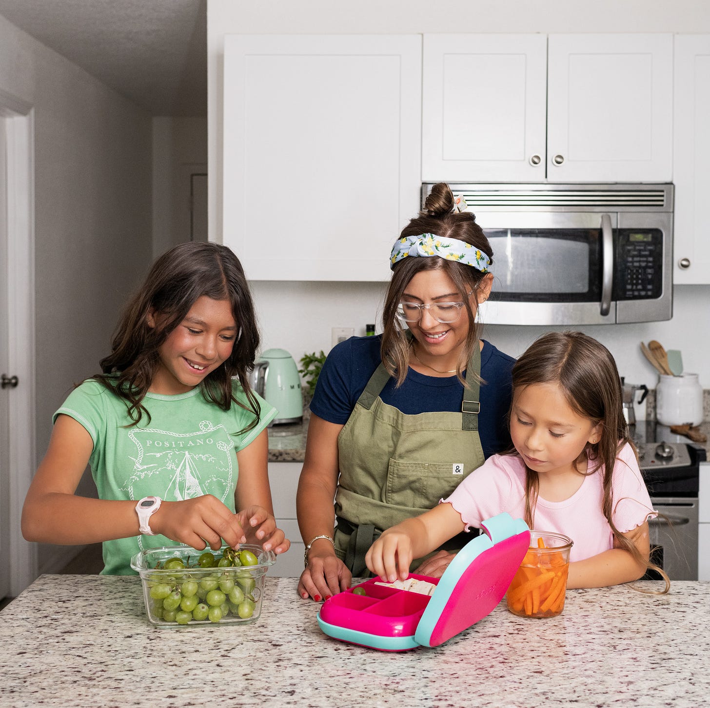 Kris and two daughters, Sage and Wren packing up a lunch box Kris and two daughters, Sage and Wren packing up a lunch box