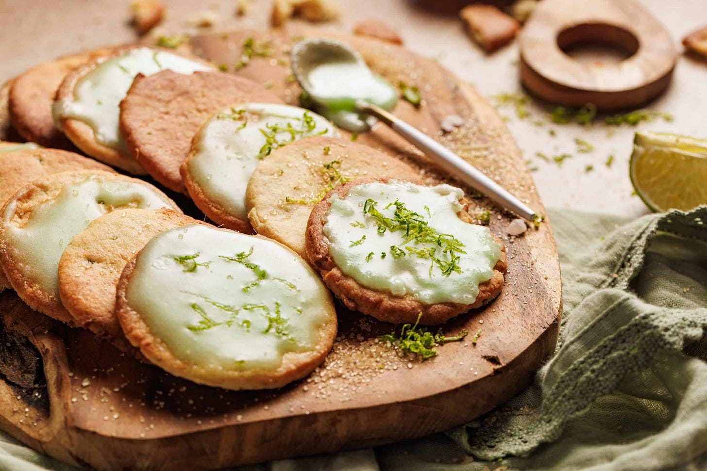 Gorgeous lemongrass cookies recipe on a cutting board with green icing and sugar. 