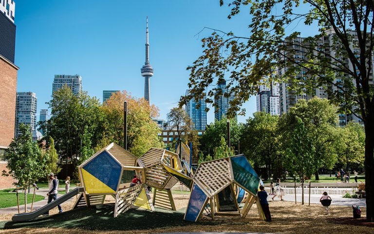 Grange park — a playground in the foreground, the CN tower in the background.