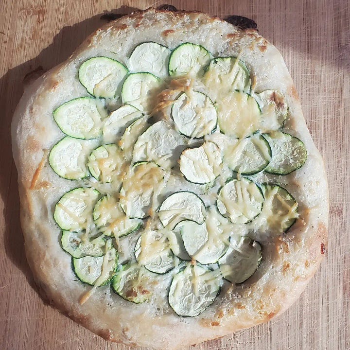 Zucchini Pizza from Cleveland cooking. Garlic cream sauce topped with sliced zucchini.