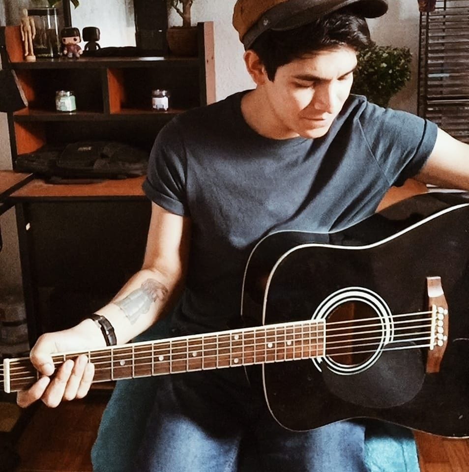 Puede ser una imagen de 1 persona, guitarra e interior