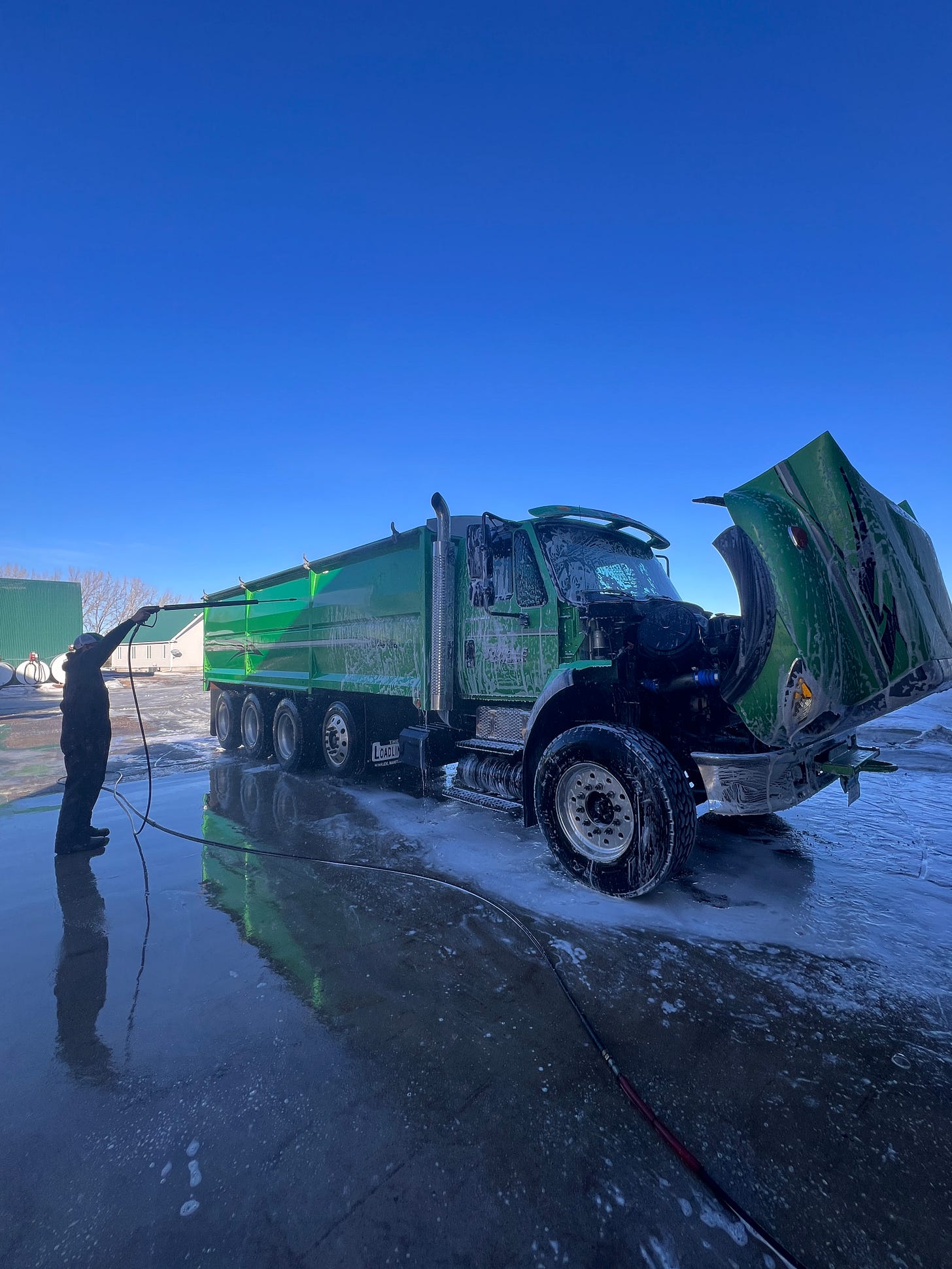 Washing a grain truck outdoors in late January