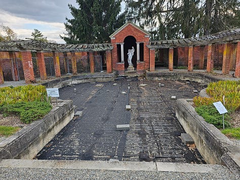 The garden with brick gazebo and fountain that is not running.