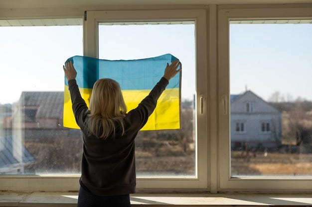 Premium Photo | Woman wrapped in Ukraine flag looking out of the window.  copy space