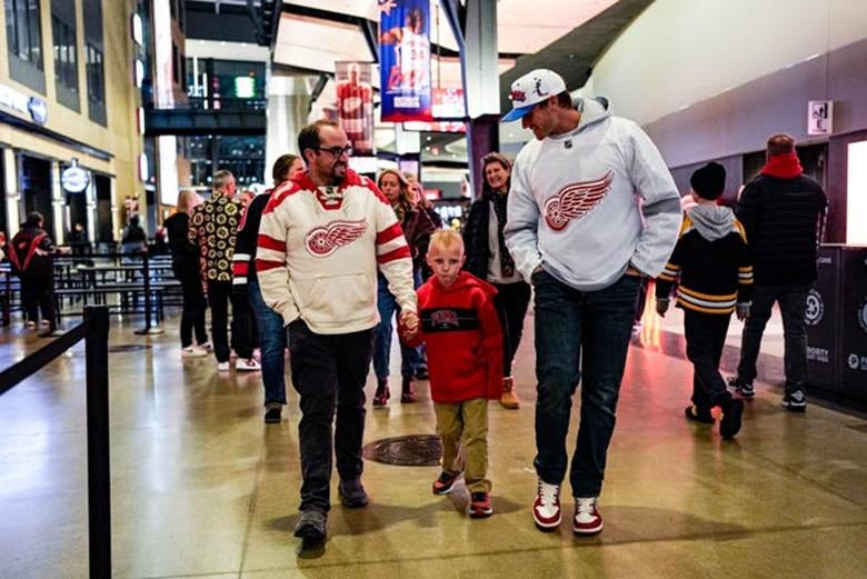 Detroit Tigers pitcher Sawyer Gipson-Long, right, walks with Cailen Vela, 7, center, and his father Cody Vela on the course at Little Caesars Arena in Detroit before attending a a game between Detroit Red Wings and Boston Bruins on Tuesday, Dec. 2, 2025.