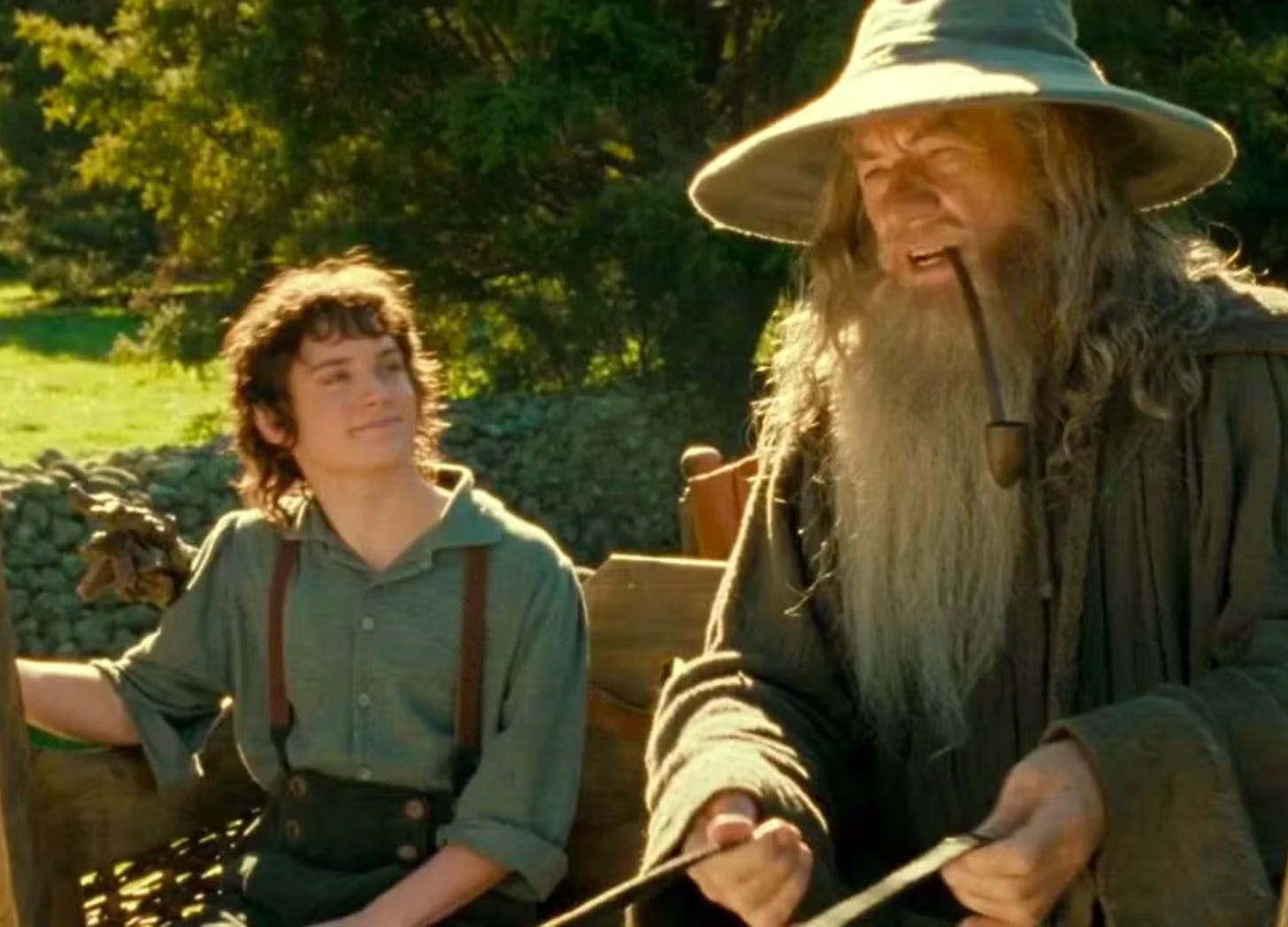 Frodo and Gandalf chat on a bench Frodo and Gandalf chat on a bench