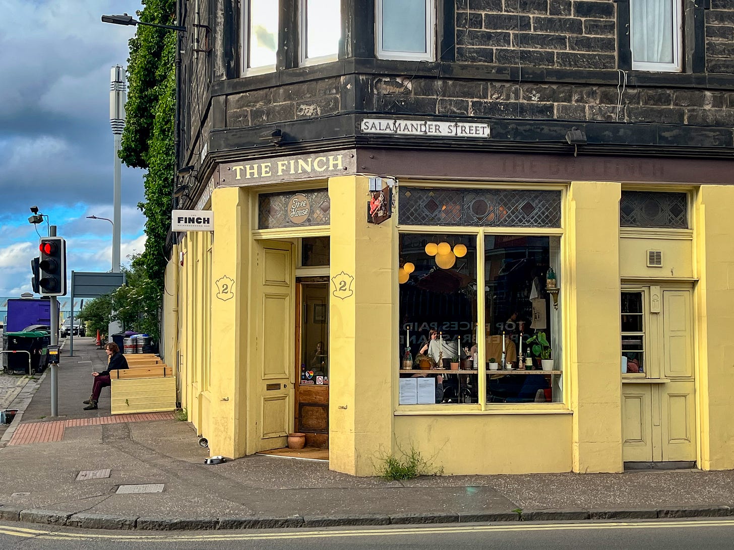 A bright yellow pub exterior on the corner of the road