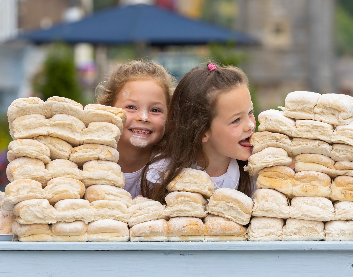 Children eating blaas, a floury white bread roll from Waterford, Ireland
