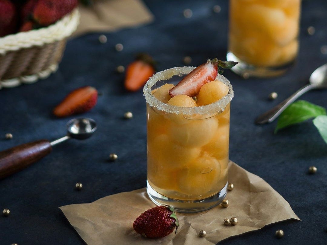 clear drinking glass with yellow liquid