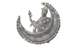 This may contain: an old metal brooch with a man on it's back holding a bird