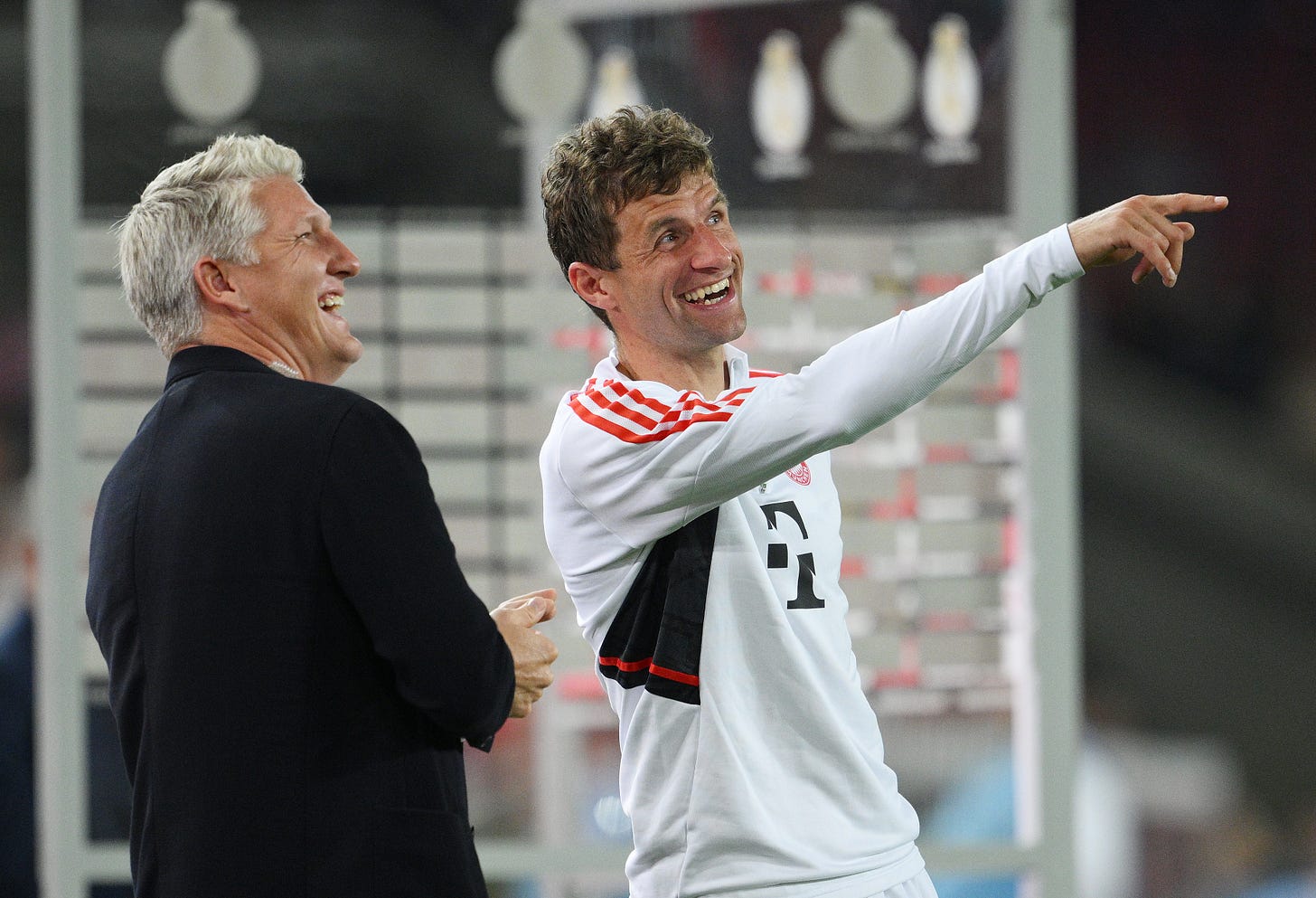 Thomas Muller points something out to a laughing Bastian Schweinsteiger.