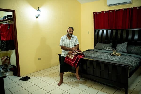 Mr. Khan and his cat in his bedroom. Mr. Khan and his cat in his bedroom.