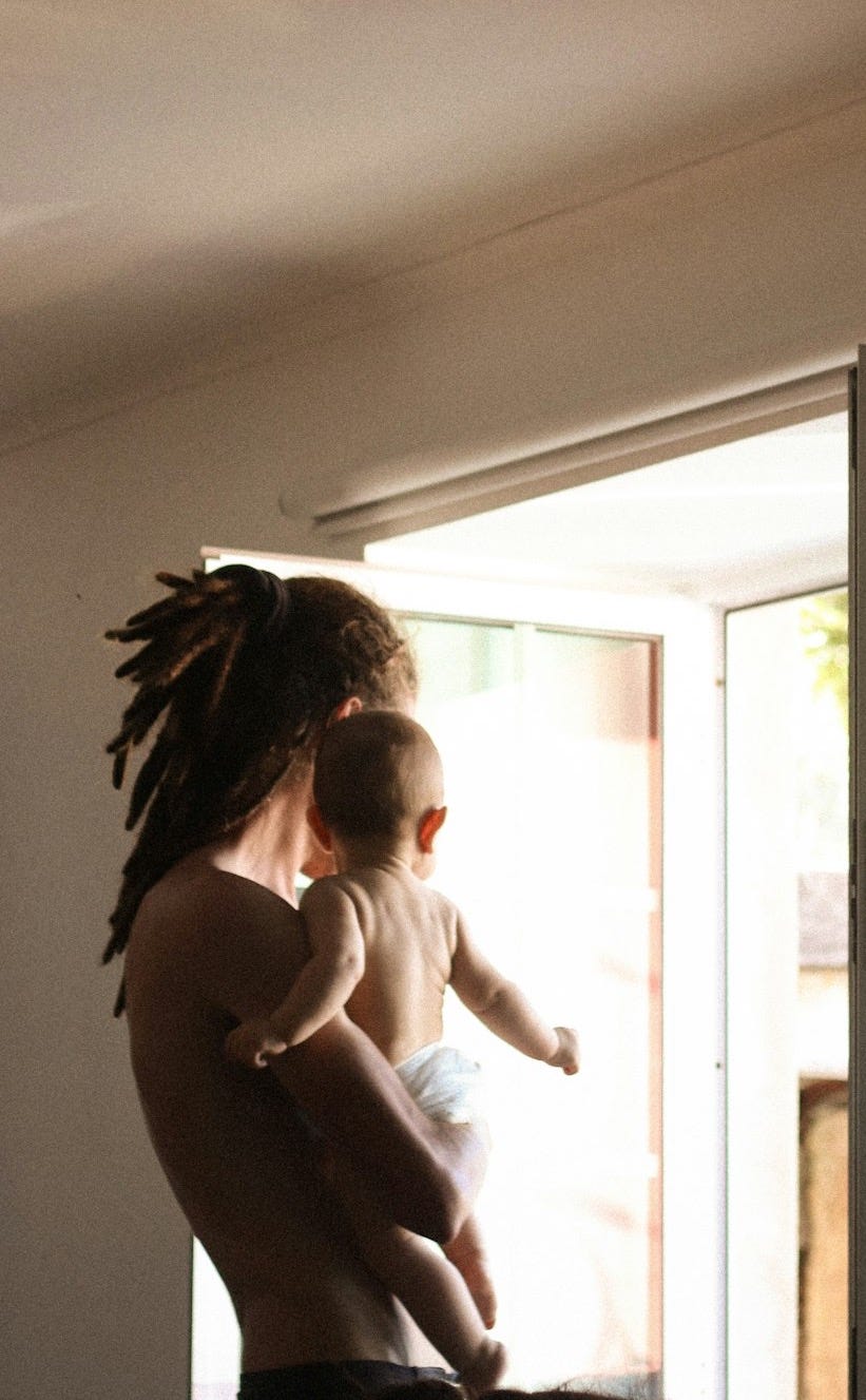 A woman holding a baby in her arms