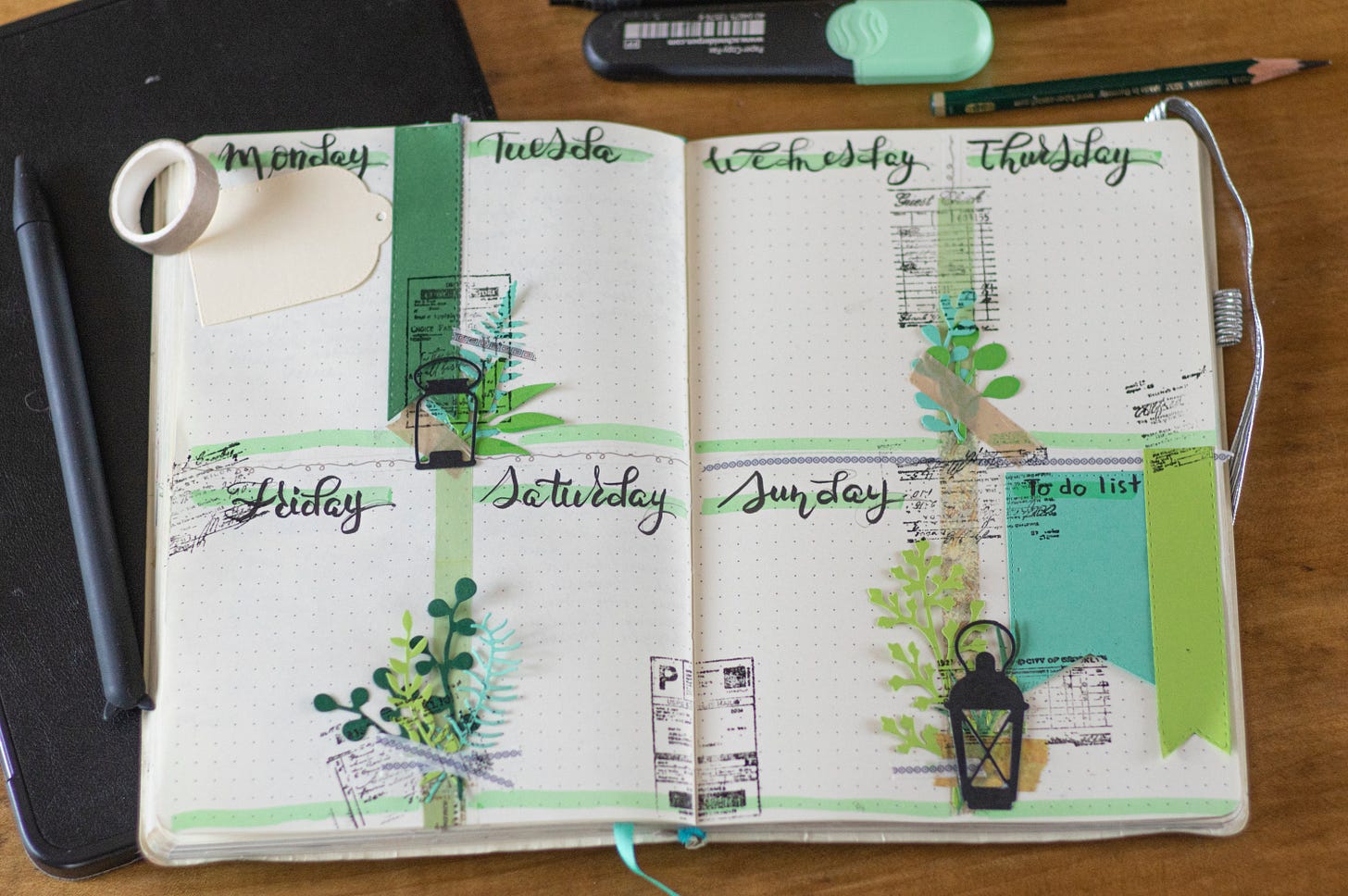 open dot grid notebook elaborately decorated with calligraphy and other images