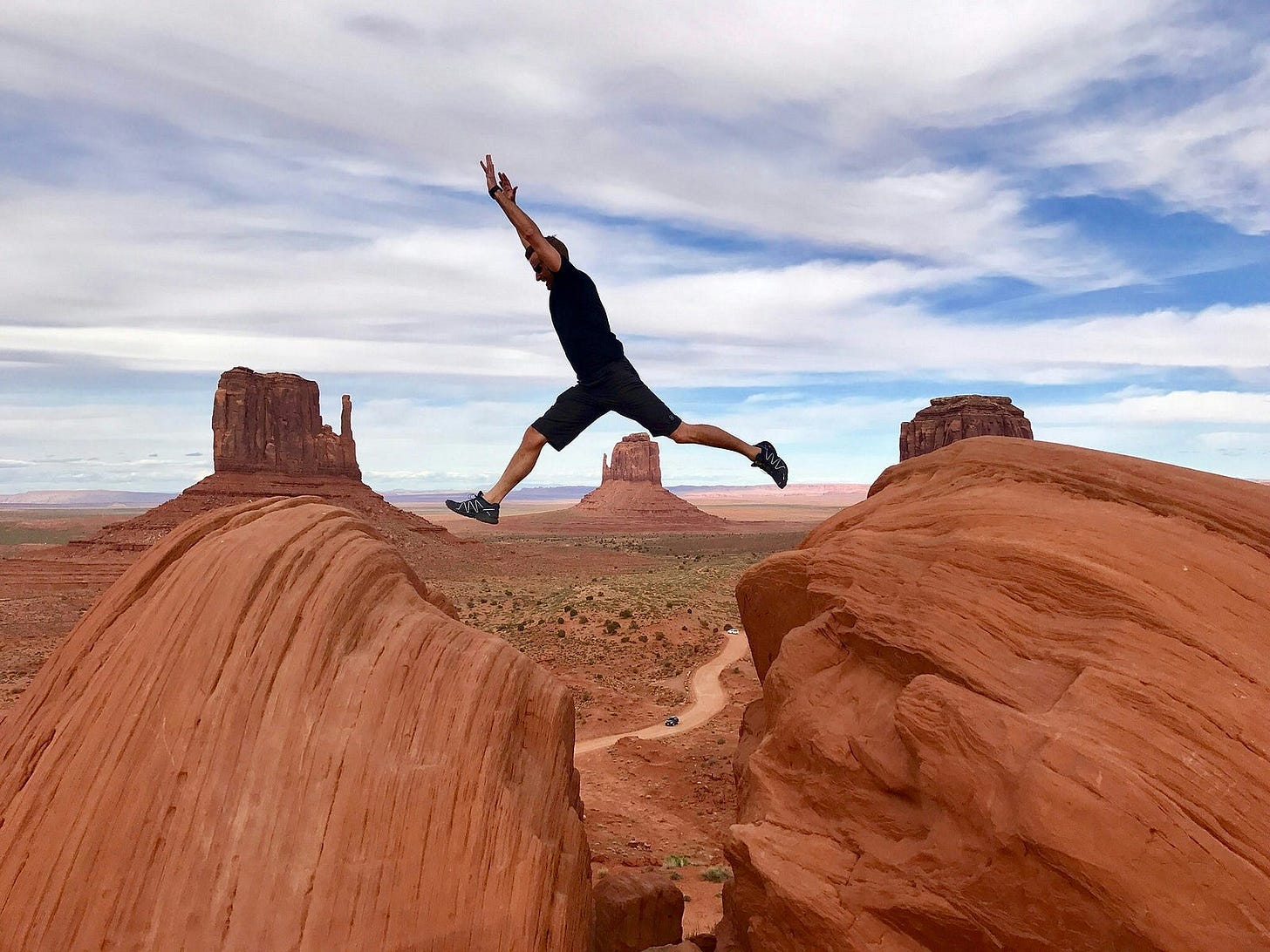 man jumping from rock to rock man jumping from rock to rock