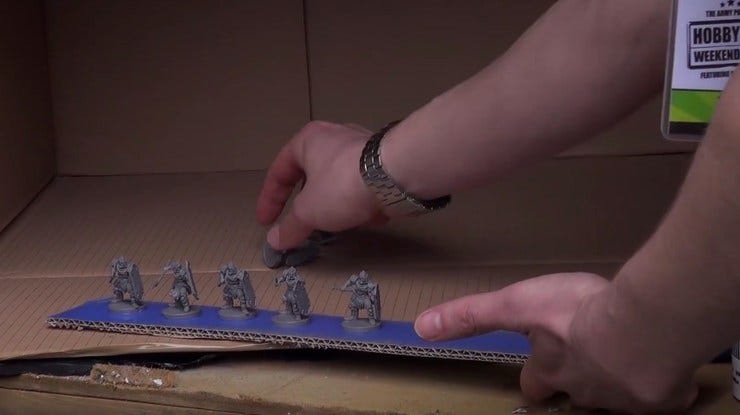 Holding parts to a painting stick using paint.