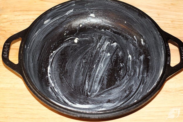 Butter the interior of a high-heat baking pan or cast-iron skillet liberally with ½ tablespoon butter. Butter the interior of a high-heat baking pan or cast-iron skillet liberally with ½ tablespoon butter.