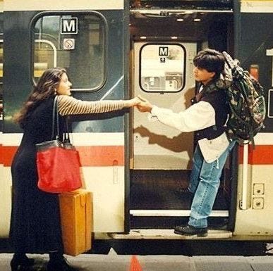 This may contain: two women are shaking hands at the door of a train