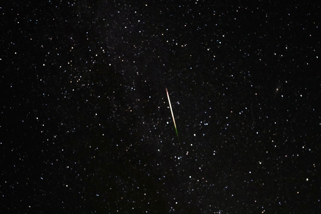 A picture containing outdoor object, night, comet, dark

Description automatically generated