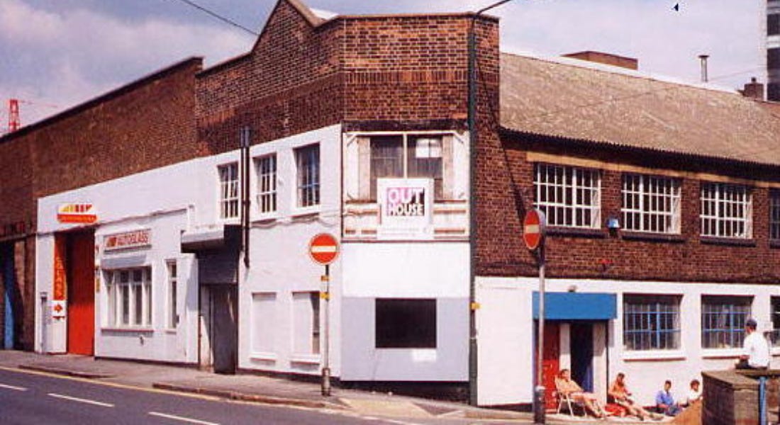 A brick building with a white exterior and windows