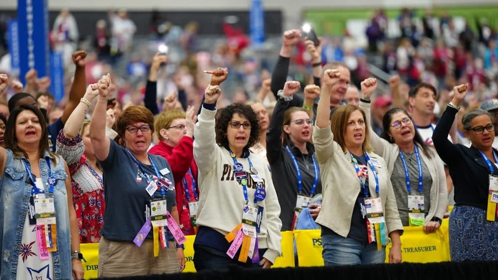 Delegates raise solidarity fists at the NEA's 2025 Representative Assembly. (Photo: National Education Association)