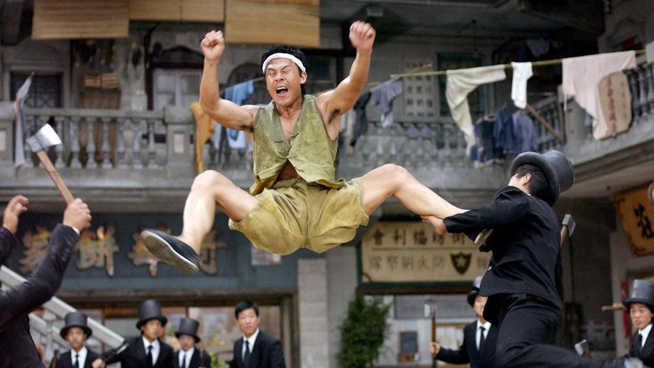 Asian man leaping in air in a courtyard and kicking people attacking him