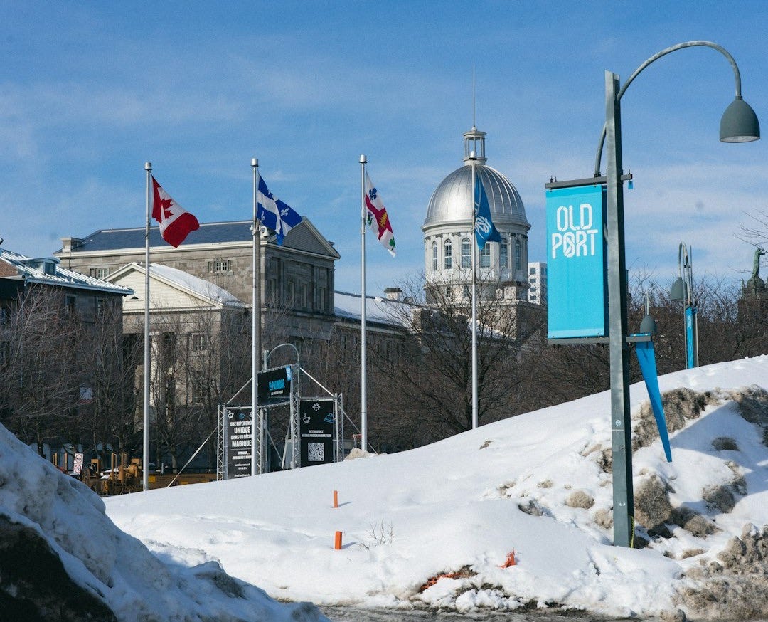 a street sign in front of a snow covered road a street sign in front of a snow covered road