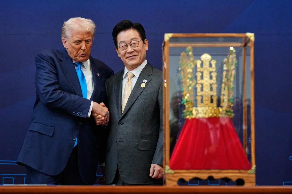 President Donald Trump shakes hands with South Korean President Lee Jae Myung as he receives a gift of a gold crown and an award of the Grand Order of Mugunghwa, not seen, during a high honor ceremony at the Gyeongju National Museum in Gyeongju, South Korea, on Oct. 29, 2025.