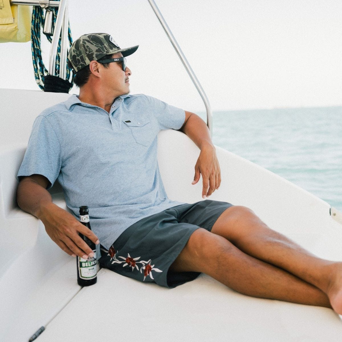 a man on a boat wears the howler brothers ranchero polo