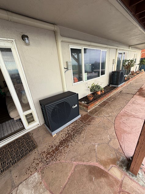 The images are of the back of a house with two fairly prominent black heat pumps, and electrical conduits sneaking across all of the walls.