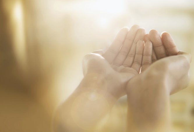 two hands held up and open, as if waiting to receive a gift