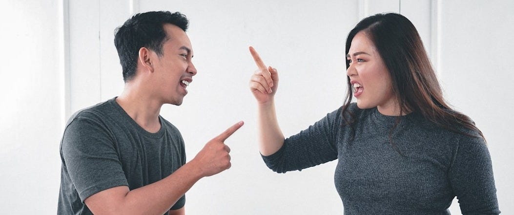 man in gray crew neck long sleeve shirt standing beside woman in black crew neck shirt man in gray crew neck long sleeve shirt standing beside woman in black crew neck shirt